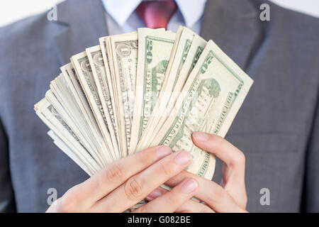 Businessman holding bank notes en blanc fond isolé Banque D'Images