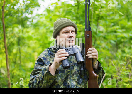 Hunter avec fusil optique et des jumelles dans le w Banque D'Images