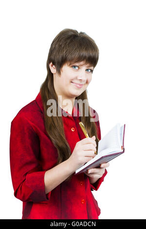 Belle jeune fille avec carnet et un stylo sur un livre blanc Banque D'Images