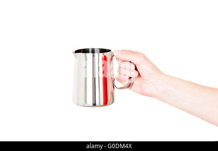 Chaudière en acier inoxydable pot de lait dans la main isolated on white Banque D'Images