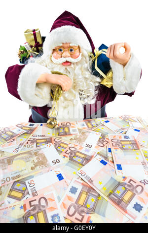 Modèle de Père Noël avec des cadeaux et de l'argent euro Banque D'Images