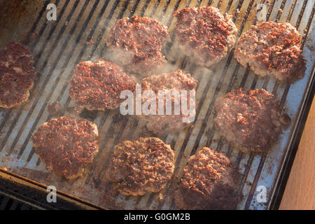 Étant des burgers de bœuf grillées sur barbecue. Banque D'Images