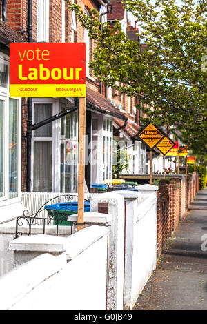 Rangée de maisons mitoyennes afficher les partis en période électorale signes pôle, Watford, Hertfordshire, England, UK Banque D'Images