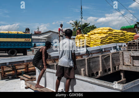 Les travailleurs chargés des sacs de ciment dans la coque d'un bateau au port de Paotere à Makassar, Indonésie. Banque D'Images