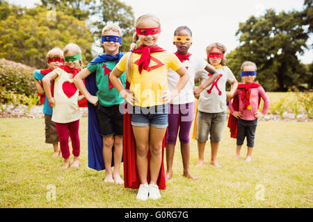 Enfants wearing superhero costume standing Banque D'Images