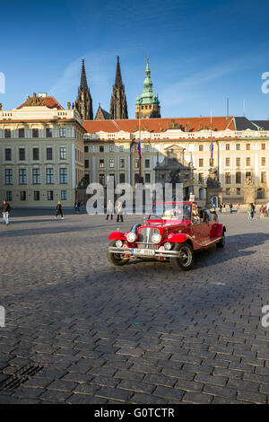 Vintage voiture rouge pour les touristes des manèges, Hradcanske namesti, le château de Prague, République Tchèque, Europe Banque D'Images