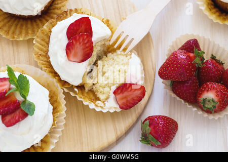Cupcakes fraise fait maison avec de la crème fouettée topping, vue d'en haut Banque D'Images