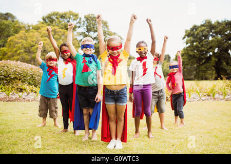 Enfants wearing superhero costume standing Banque D'Images