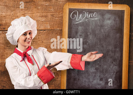 Image composite de jolie chef presenting with hands Banque D'Images