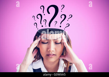 Image composite de nervous businesswoman holding sa tête Banque D'Images