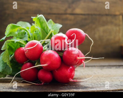 Bunch of fresh radishes on wooden table Banque D'Images