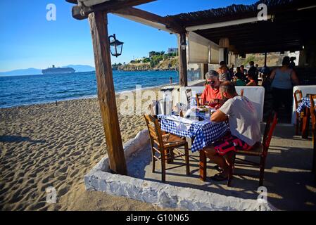 Niko¥s Place Taverna en plage derrière les moulins à vent de Mykonos, avec vue sur des navires de croisière, îles grecques, Grèce Banque D'Images