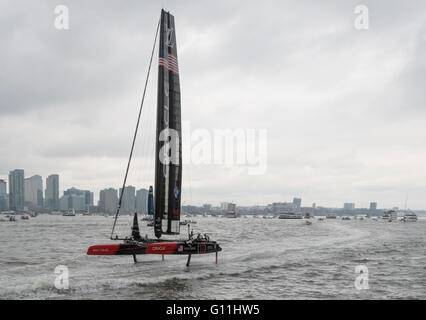 L'équipe Oracle USA yacht à déjouer qu'ils sont remorqués passé les spectateurs dans le 2016 America's Cup World Series à New York sur la rivière Hudson. Banque D'Images