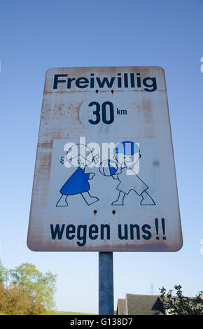 Pilotes demandant des panneaux routiers à choisi de route 30km/h pour l'amour des enfants Banque D'Images