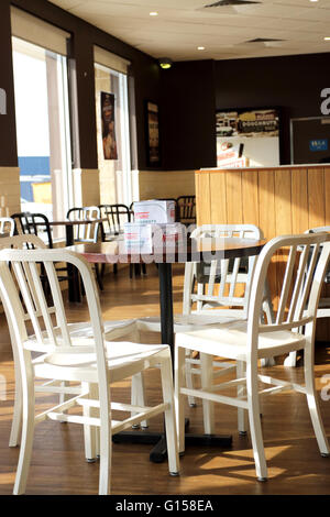 En manger Krispy Kreme cafe avec chaises en bois blanc et brun tableau Banque D'Images