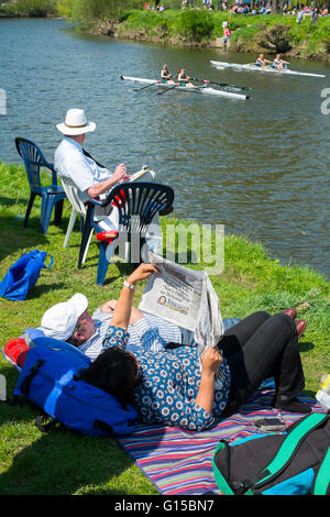 Les spectateurs se détendre en regardant les rameurs en compétition dans Shrewsbury régate sur la rivière Severn, Shropshire. Banque D'Images