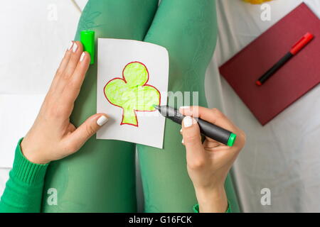 Girl in green dimensions un trèfle sur une carte de vœux Banque D'Images