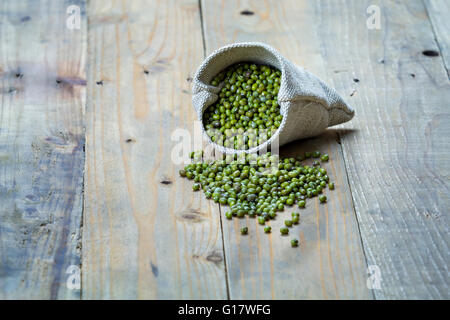 Les haricots mungo dans sac sur planches de bois vintage Banque D'Images