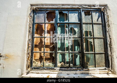 Fenêtre cassée sur l'ancien bâtiment détruit l'abandon des panneaux de verre bâtiment abandonné Banque D'Images