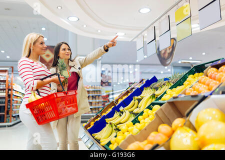 Belles femmes shopping fruits et légumes en supermarché Banque D'Images