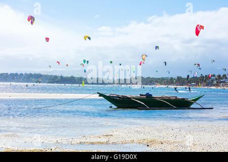 L'île de Boracay, Philippines - 01 février : kitesurfeurs bénéficiant d'énergie éolienne sur la plage de Bulabog, petit bateau en premier plan Banque D'Images