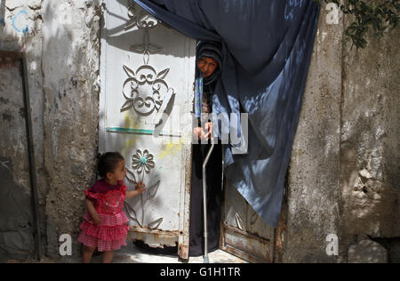 Khan Younis, dans la bande de Gaza, territoire palestinien. 15 mai, 2016. Une femme palestinienne est à l'extérieur de sa maison sur la 68e anniversaire de la Nakba '''' dans le sud de la bande de Gaza ville de Khan Younis, le 15 mai 2016. ''Nakba'' signifie en arabe ''catastrophe'' en référence à la naissance de l'état d'Israël il y a 68 ans de la Palestine-, qui a entraîné le déplacement de centaines de milliers de Palestiniens qui ont fui ou ont été chassés de leurs foyers lors de la guerre de 1948 sur la création d'Israël. La clé symbolise les maisons laissées par les Palestiniens en 1948 (Crédit Image : © Abed Rahim Banque D'Images