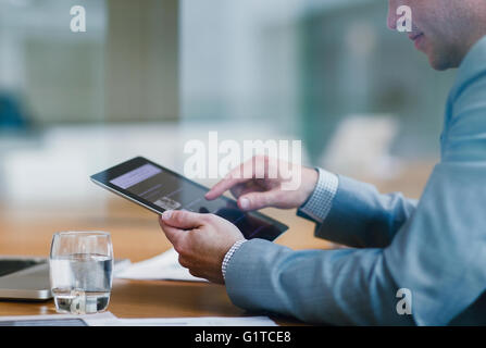 Businessman using digital tablet in office Banque D'Images