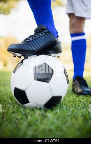 Vue en gros de chaussures de football sous ballon Banque D'Images