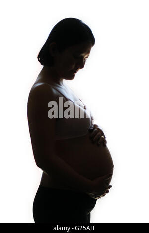 Silhouette d'une femme enceinte holding belly Banque D'Images