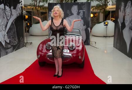 Sosie de Marilyn Monroe officiel Suzie Kennedy pose sur une voiture d'époque pour lancer l'héritage d'une légende exposition au centre de Design à Londres. Banque D'Images