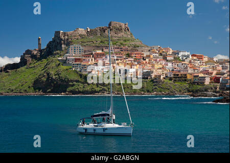 Castelsardo, Sassari, Sardaigne, Italie, 10/4/2016.Bateau à voile sur la mer en face de la ville colorée de Castelsardo, près du port. Banque D'Images