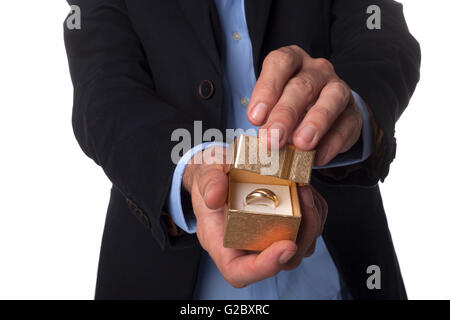 Man in Suit Holding Main bijoux en or fort isolé sur fond blanc Banque D'Images