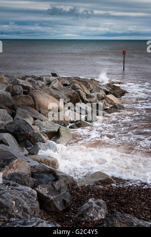 Brise-lames sur la côte sud du Jurassique montrant diverses couleurs rock et brown mer. Banque D'Images