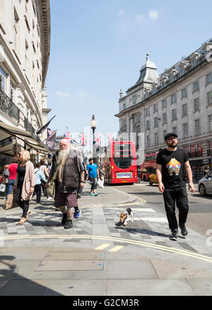 Un vieil homme barbu promène son chien Jack Russell le long de Regent Street, près de Piccadilly Circus, au centre de Londres Banque D'Images