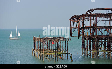 Brighton Sussex UK 29 mai 2016 - un yacht sails passé la jetée Ouest abandonné au large de la plage de Brighton en bel ensoleillement tôt ce matin que le temps devrait rester au chaud et ensoleillé pour le reste de la bank holiday weekend Crédit : Simon Dack/Alamy Live News Banque D'Images