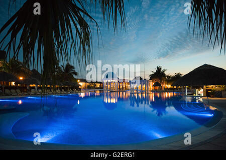 Vue horizontale sur une piscine éclairée la nuit dans un hôtel à Varadero, Cuba. Banque D'Images