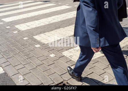 Les gens à l'aide d'un passage pour piétons à Chelmsford, Essex, Angleterre avec juste les jambes et pieds visibles, pas de visages. Banque D'Images