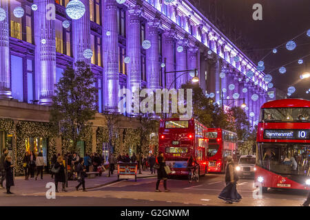 Les bus londoniens passant par Selfridges sur Oxford St à Noël sont occupés avec des acheteurs de Noël et des gens regardant les lumières de Noël, Londres, Royaume-Uni Banque D'Images