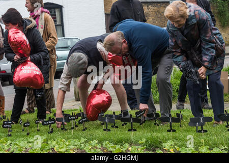 Harmondsworth, Londres, Royaume-Uni. 30 mai, 2016 HACAN et anti-3ème campagne en piste d'Harmondsworth "célébrer" le 70e anniversaire d'Heathrow avec '70 Pas de 3ème piste' ballons et planter plus de 750 avions noirs sur le village vert, représentant le nombre de maisons qui seront détruites. Crédit : Peter Marshall/Alamy Live News Banque D'Images