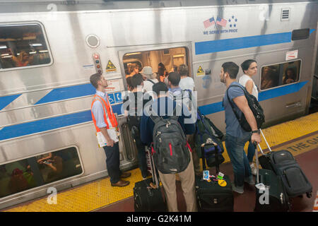 Des milliers pack la Cannonball à Penn Station à New York, pour sortir de la ville pour le week-end du Memorial Day, le vendredi 27 mai, 2016. Chaque vendredi durant l'été, le train, composé de wagons à impériale tiré par une puissante locomotive bi-mode, se déroulera express à Westhampton sur Long Island rendant le 76 kilomètres en 94 minutes. De Westhampton il continuera de points à l'est d'arriver à la pointe de l'île, Montauk. Le dimanche, le train s'inverse et retour à la gare Penn Station. Le train est le seul intitulé run sur le chemin de fer. Le voyage de Penn Station à la borne est 117 Montauk Banque D'Images