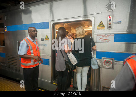 Des milliers pack la Cannonball à Penn Station à New York, pour sortir de la ville pour le week-end du Memorial Day, le vendredi 27 mai, 2016. Chaque vendredi durant l'été, le train, composé de wagons à impériale tiré par une puissante locomotive bi-mode, se déroulera express à Westhampton sur Long Island rendant le 76 kilomètres en 94 minutes. De Westhampton il continuera de points à l'est d'arriver à la pointe de l'île, Montauk. Le dimanche, le train s'inverse et retour à la gare Penn Station. Le train est le seul intitulé run sur le chemin de fer. Le voyage de Penn Station à la borne est 117 Montauk Banque D'Images