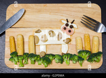 Paysage avec vaches fabriqué à partir de fromage blanc, carottes, brocoli, champignons et jambon, concept artistique Banque D'Images