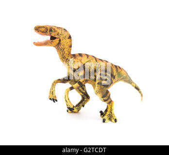 Vue côté jouet velociraptor jaune sur fond blanc Banque D'Images