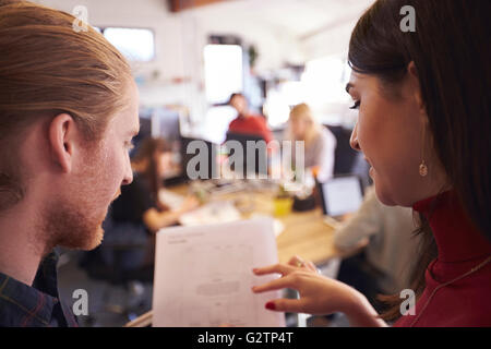 Deux designers à la recherche de document en Bureau actif Banque D'Images