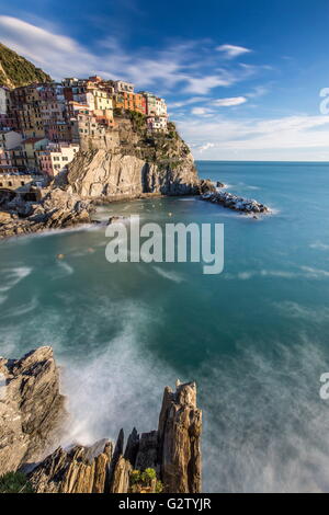 Vue sur le typique village de Manarola entouré par le bleu de la mer et les falaises du parc national de Cinque Terre Ligurie Italie Europe Banque D'Images