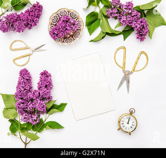 Sketchbook, lilas fleurs, outils et accessoires de bureau. Mise à plat, vue du dessus de l'ordinateur portable Banque D'Images