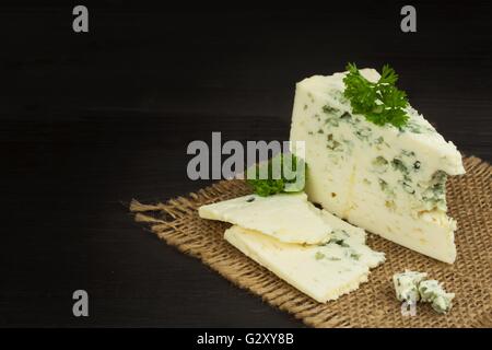 Bleu danois. Fromage bleu close up sur une vieille table en bois avec des épices. La préparation des aliments le fromage bleu. Fromage sur la table de cuisine. Banque D'Images