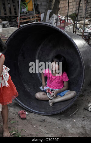 Thaïlande pauvreté. Enfants jouant parmi les décombres dans un arrière-rue thaïlandais. Thaïlande S. E. Asie. Taudis pour enfants Banque D'Images