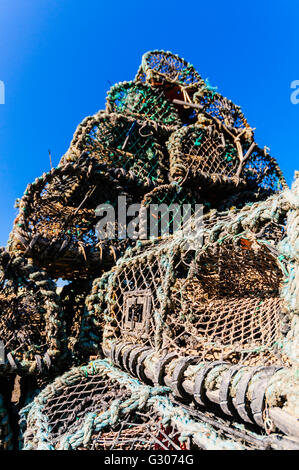 Les pièges cages à homard empilés à un port de pêche. Banque D'Images