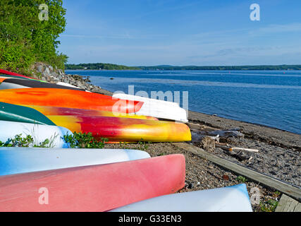 Avis de plusieurs canots, kayaks et canots stockés sur une plage à Northport Maine tôt le matin la lumière. Banque D'Images